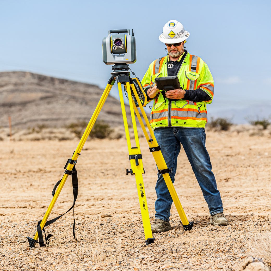 Surveyor running construction layout with a robotic total station