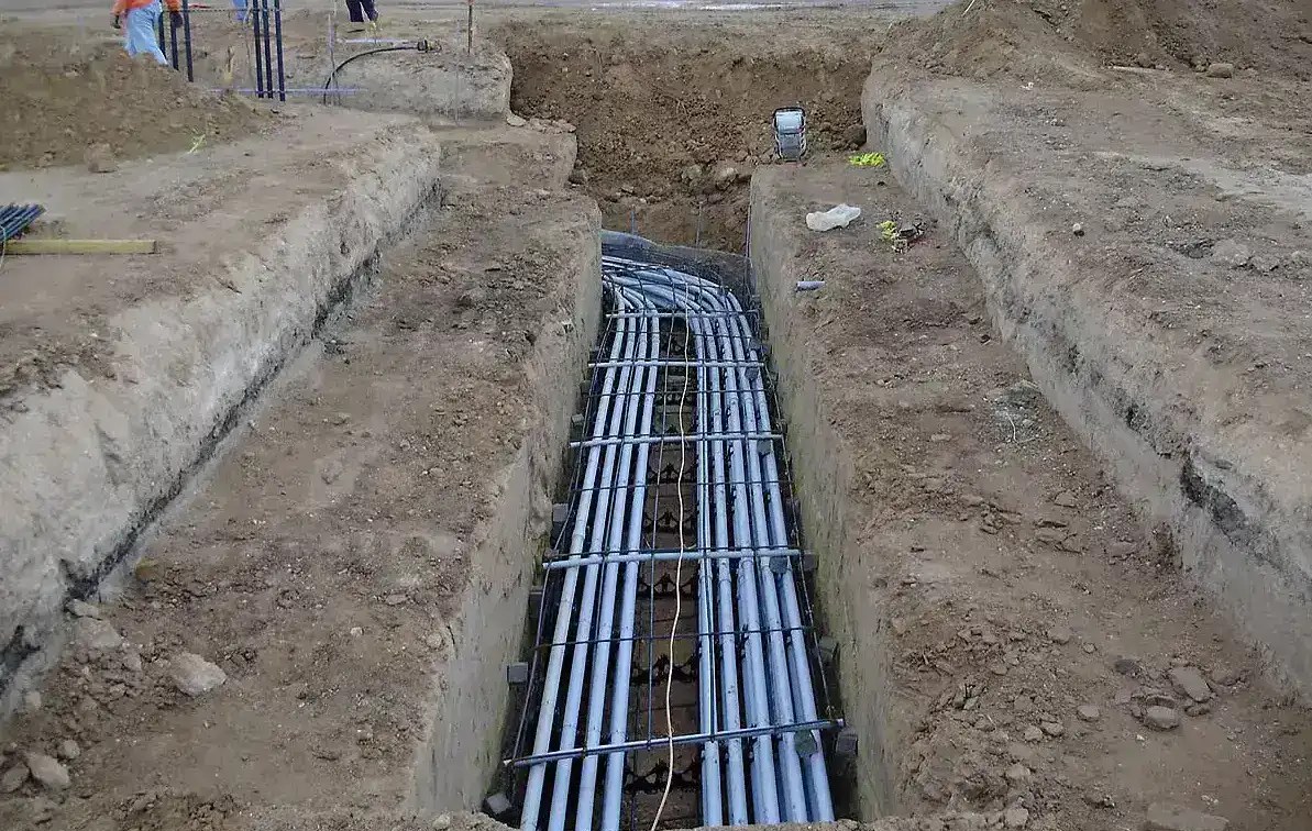 Concrete encased duct bank under construction with conduit on spacers