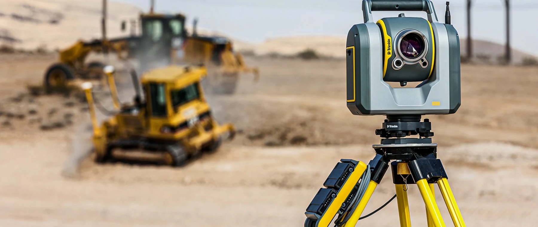 GPS-guided excavator and dozer grading a site